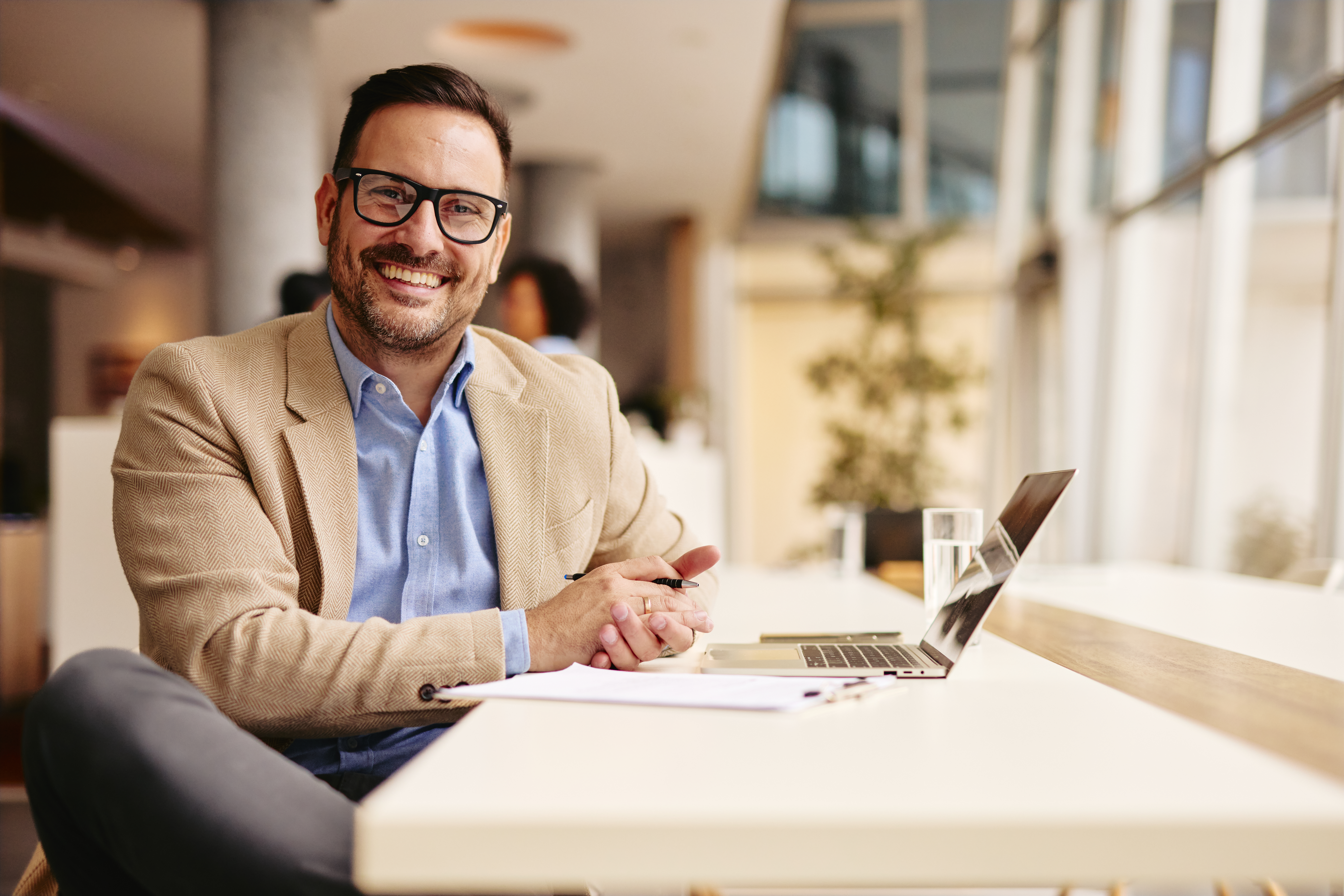 Man smilling working at computer representing talent management consulting