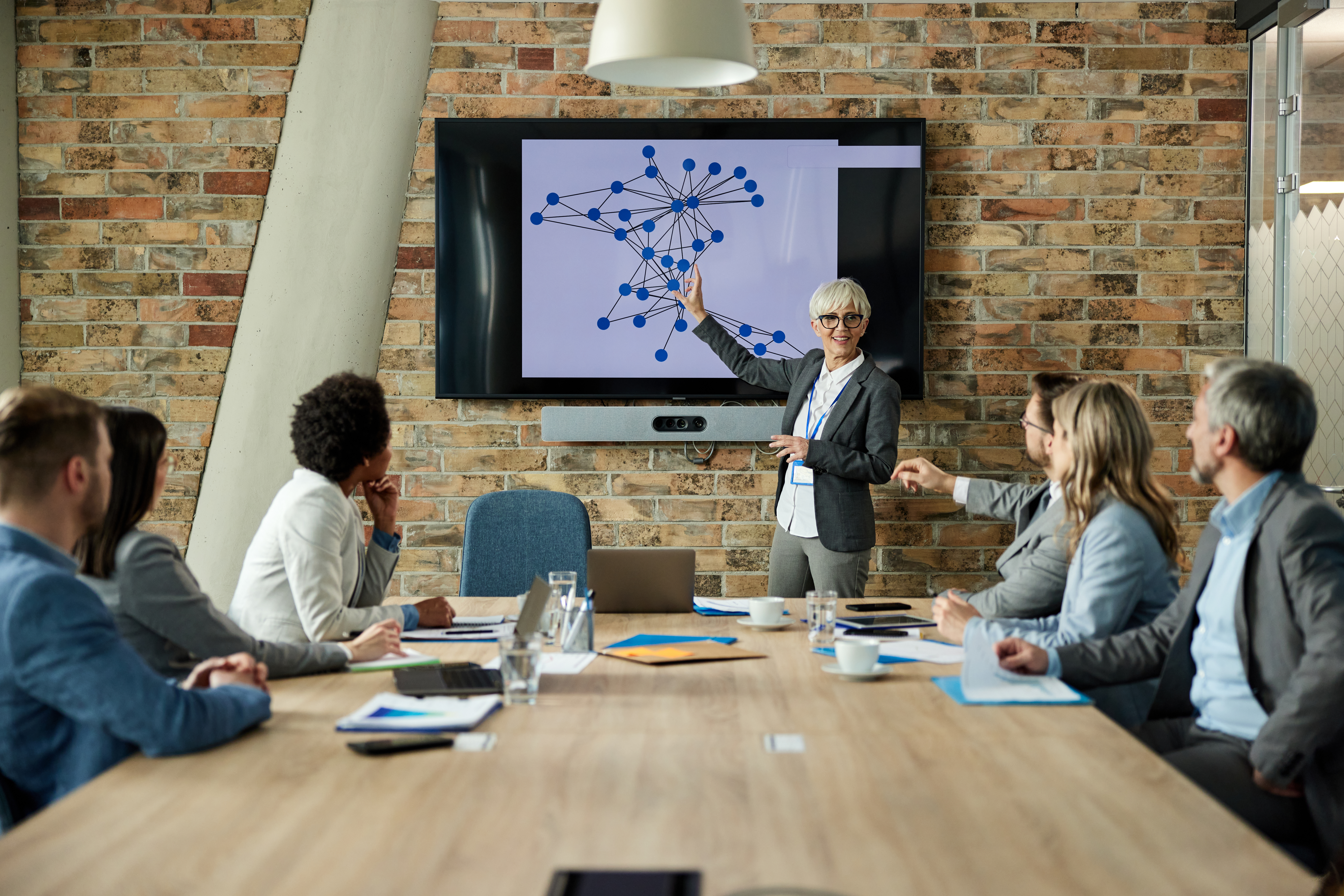 Senior female CEO leading a meeting representing technology roadmap consulting