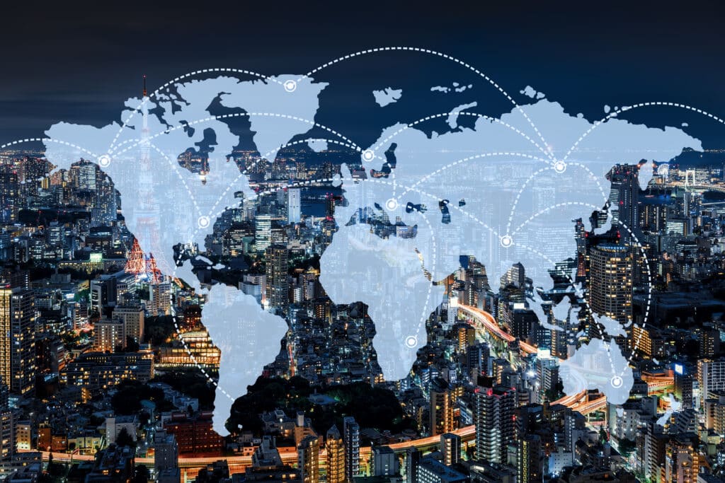 World map overlay on a cityscape at night, illustrating international expansion consulting.