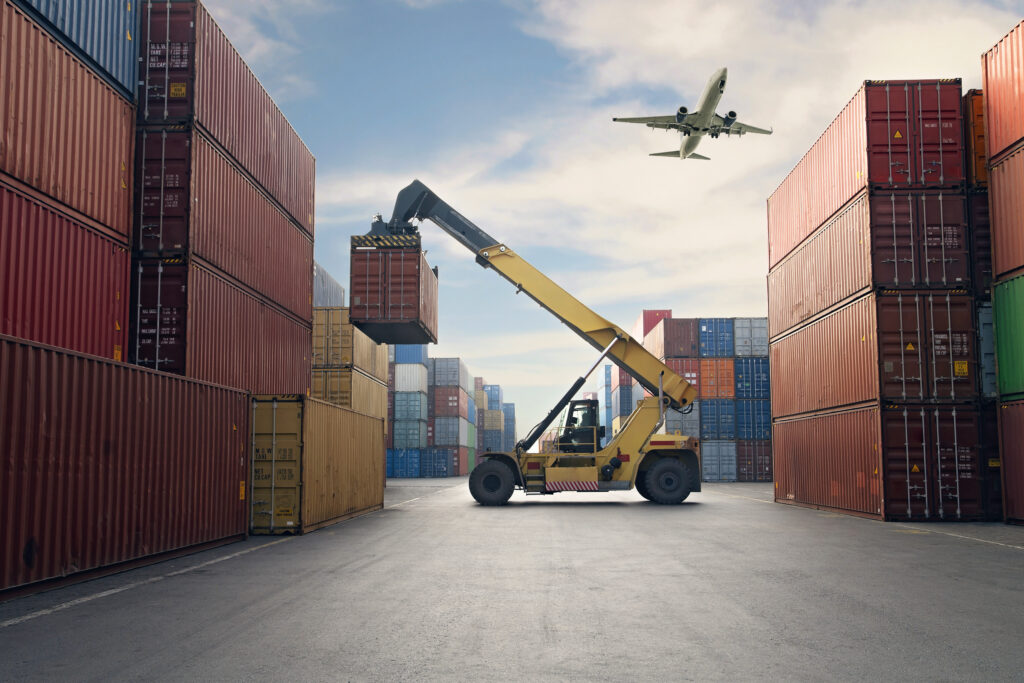 Airplane flying above container port representing Airplane flying above container port.