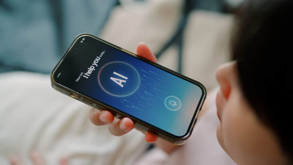 Person holding a smartphone with an AI virtual assistant for the Agentic Hotel Guest on screen.