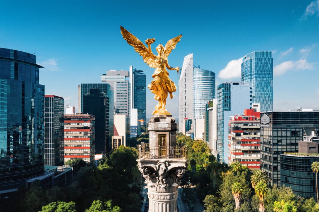 Mexico City skyline and Independence Monument for P&C Global Mexico City office announcement on Avenida Presidente Masaryk.