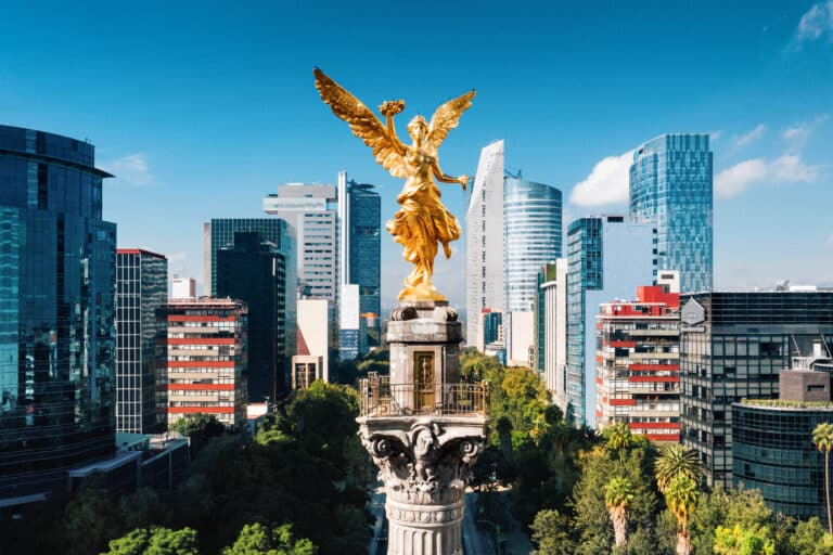 Mexico City skyline and Independence Monument for P&C Global Mexico City office announcement on Avenida Presidente Masaryk.